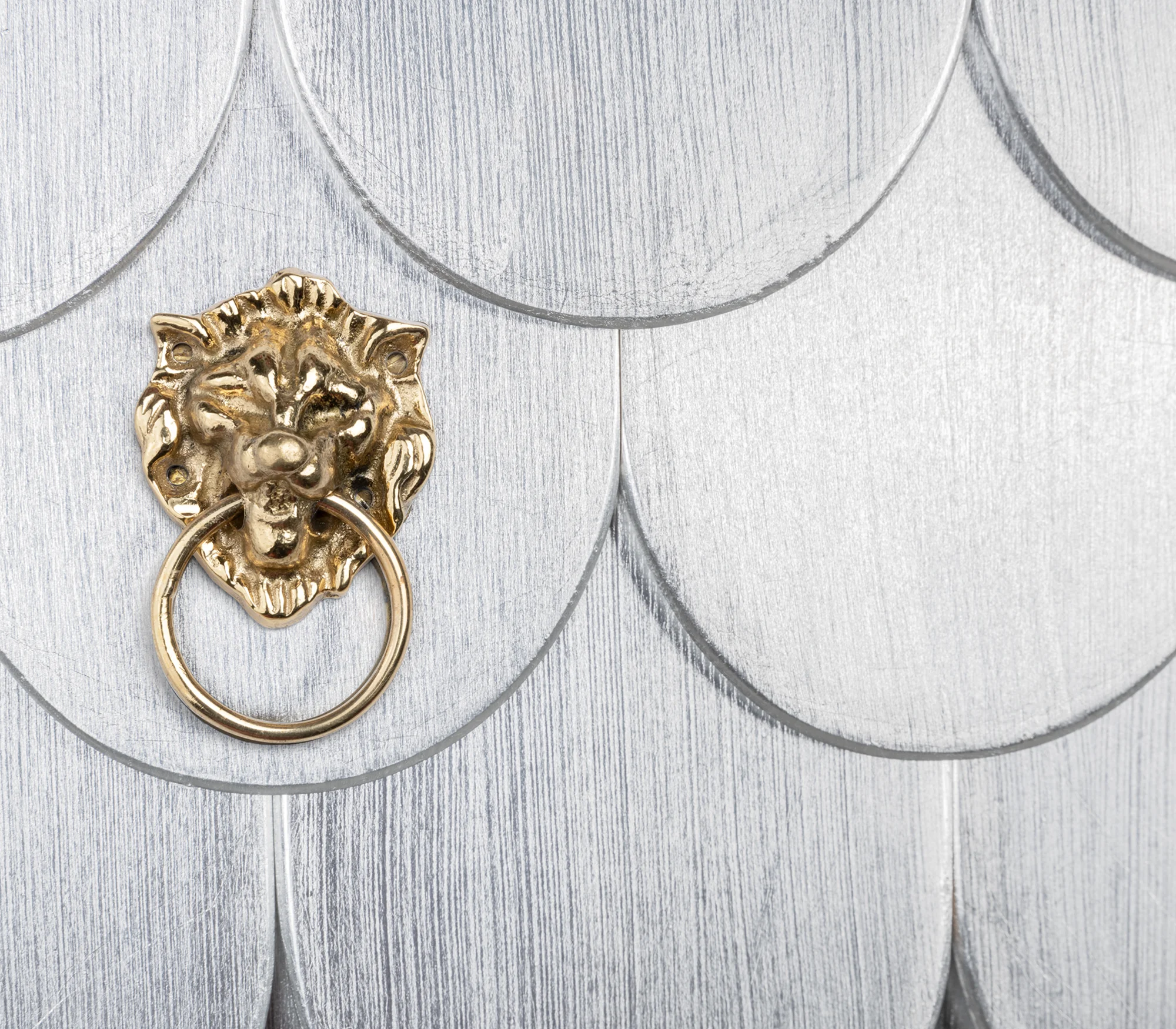 Silver scalloped drawer with a gold lion-ring handle on the Coleccionista Black Bookcase
